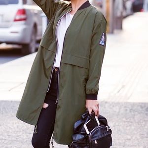 Green bombers jacket with sticker on